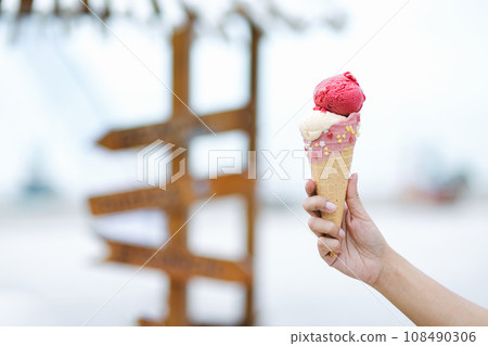Mix berry and vanilla ice cream cone on hand Mix berry and vanilla ice cream cone on hand 108490306
