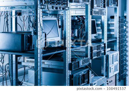 back side of server racks and desktop computer used by network administrator 108491537