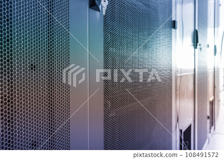 Data center with a row of server racks 108491572