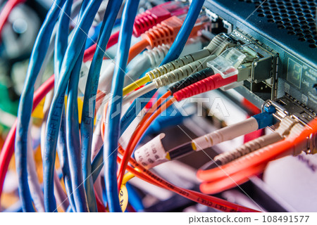 Detail of server with patch cables plugged in ethernet ports Detail of server with patch cables plugged in ethernet ports 108491577