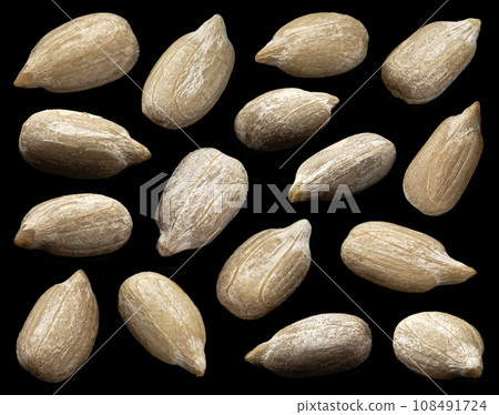 Peeled sunflower seeds on black background 108491724