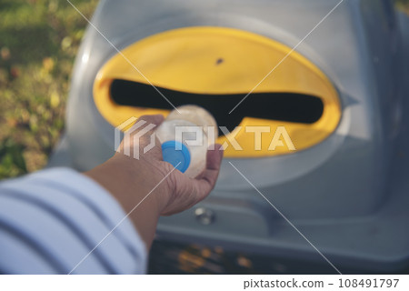 Men hands trow Trash cans for sorting garbage recycle bin waste plastic container collection. Reuse, reduce, recycle sorting process sustainable lifestyle rubbish dustbin plastic box in green garden Men hands trow Trash cans for sorting garbage recycle bin waste plastic container collection. Reuse, reduce, recycle sorting process sustainable lifestyle rubbish dustbin plastic box in green garden 108491797