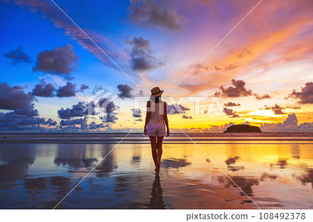 Traveler asian woman travel on Phuket beach in sunset Thailand 108492378