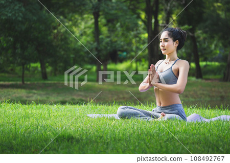 Fit asian woman doing yoga meditation in park fitness and heakthy outdoor concept 108492767