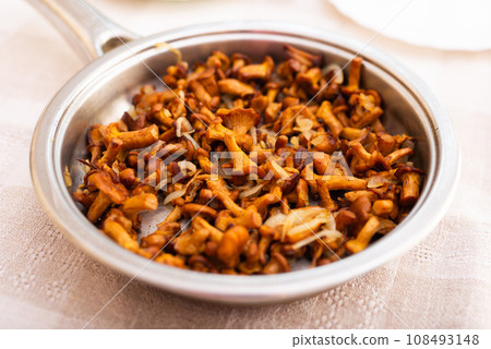 Deliciously fried chanterelle mushrooms in a frying pan Deliciously fried chanterelle mushrooms in a frying pan 108493148