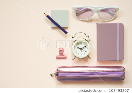 Light purple office supply stationery on pink desk background. flat lay, top view Light purple office supply stationery on pink desk background. flat lay, top view 108493297