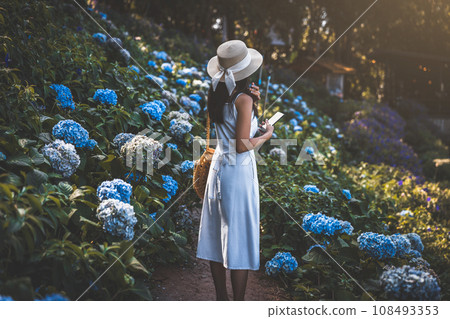 Traveler woman with mobile phone travel in flower garden at Chiang Mai Thailand Traveler woman with mobile phone travel in flower garden at Chiang Mai Thailand 108493353
