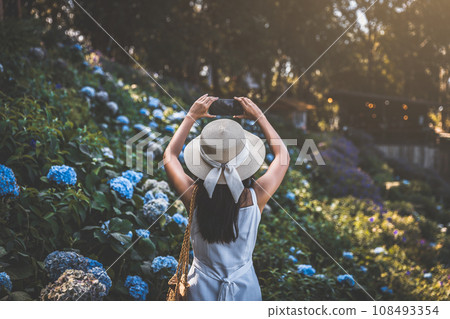 Traveler woman with mobile phone travel in flower garden at Chiang Mai Thailand 108493354