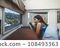 Travel woman with mobile phone relax inside a camper car recreational vehicle 108493363