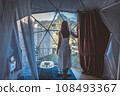 Travel woman relax inside a luxury camping dome tent 108493367