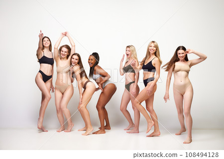 Body positive. Attractive different young women of diverse skin color, age and body shapes in underwear against white studio background 108494128