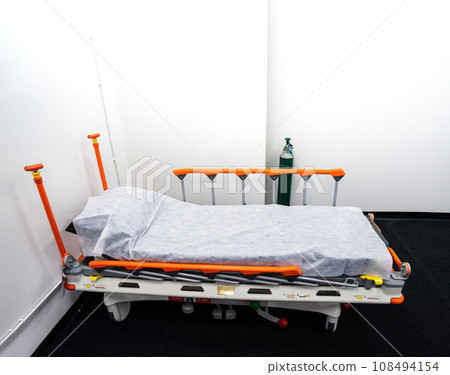 Camp bed with orange bed rails for side effect of Covid-19 vaccinated patient, it is able to be temporarily moved everywhere. This place has an equipment disinfection. Camp bed with orange bed rails for side effect of Covid-19 vaccinated patient, it is able to be temporarily moved everywhere. This place has an equipment disinfection. 108494154