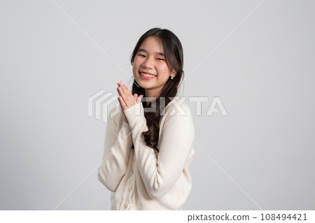 Happy cheerful young Asian girl with long light hair smiling brightly feeling happy with a positive expression, joyful surprise funky, Female in black with a big smile isolated on white background. Happy cheerful young Asian girl with long light hair smiling brightly feeling happy with a positive expression, joyful surprise funky, Female in black with a big smile isolated on white background. 108494421