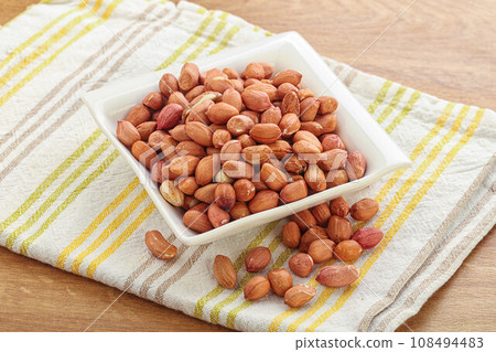 Raw peanut heap in the bowl Raw peanut heap in the bowl 108494483
