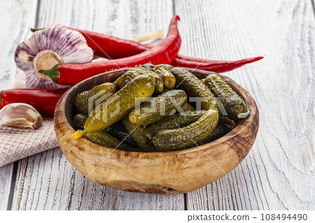 Marinated small cucumbers in the bowl Marinated small cucumbers in the bowl 108494490