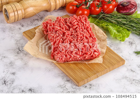 Raw minced beef meat on cutting board Raw minced beef meat on cutting board 108494515