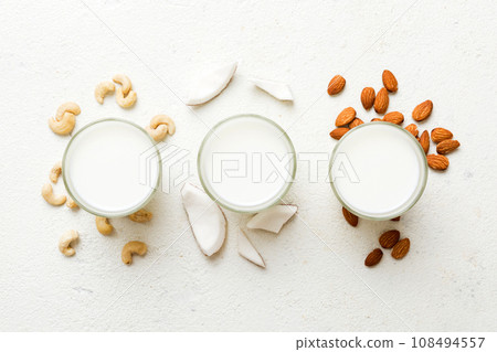 Set or collection of various vegan milk almond, coconut, cashew, on table background. Vegan plant based milk and ingredients, top view 108494557
