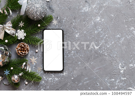 christmas mockup with space for text. christmas advertising, app template. hand holding phone with empty screen on table background. Happy New Year and Xmas Flat lay christmas mockup with space for text. christmas advertising, app template. hand holding phone with empty screen on table background. Happy New Year and Xmas Flat lay 108494597