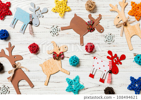 Top view of Christmas toys on wooden background. New Year ornament. Holiday concept 108494621