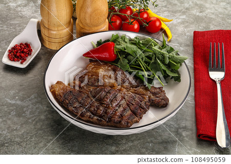 Grilled chuck roll steak with arugula Grilled chuck roll steak with arugula 108495059