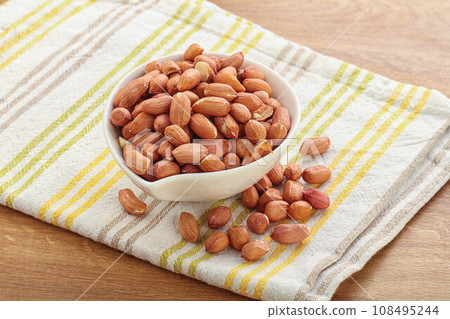 Raw peanut heap in the bowl Raw peanut heap in the bowl 108495244