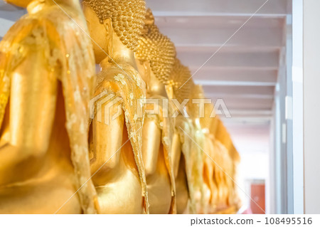 A Lot of Golden Statue of Buddha sitting meditated  in the row at Thailand Temple. 108495516