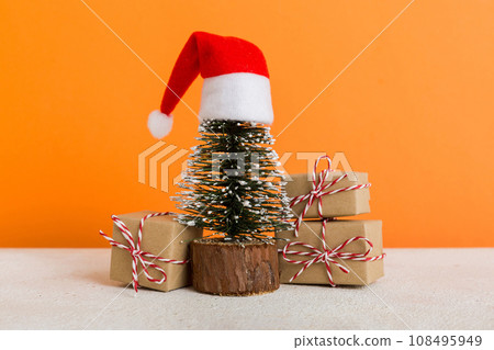 Christmas composition. Gifts, small tree, branches and craft DIY decorations on white background. New year concept. Christmas home decoration Flat lay, top view, copy space Christmas composition. Gifts, small tree, branches and craft DIY decorations on white background. New year concept. Christmas home decoration Flat lay, top view, copy space 108495949