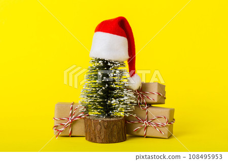 Christmas composition. Gifts, small tree, branches and craft DIY decorations on white background. New year concept. Christmas home decoration Flat lay, top view, copy space Christmas composition. Gifts, small tree, branches and craft DIY decorations on white background. New year concept. Christmas home decoration Flat lay, top view, copy space 108495953
