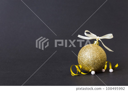 Christmas ball on colored background. decoration bauble with ribbon bow with copy space Christmas ball on colored background. decoration bauble with ribbon bow with copy space 108495992