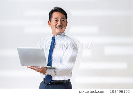 Middle-aged businessman with a computer Middle-aged businessman with a computer 108496103