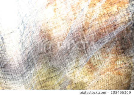Bright texture with an ethnic tone, showing a thin linen cloth with golden shades of gray Bright texture with an ethnic tone, showing a thin linen cloth with golden shades of gray 108496309