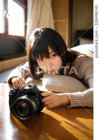 A woman lying down and touching the camera 108496541