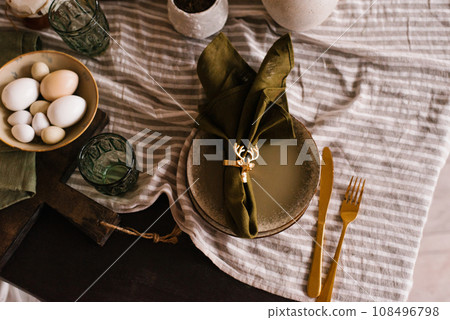 Festive serving of Christmas dinner. The plate is green, gold cutlery and a napkin with a deer 108496798