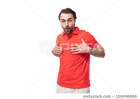 young brunette man in a red corporate t-shirt on a white background with copy space young brunette man in a red corporate t-shirt on a white background with copy space 108496999