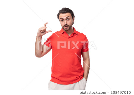 young handsome brunette man in red t-shirt gesturing on white background with copy space young handsome brunette man in red t-shirt gesturing on white background with copy space 108497010