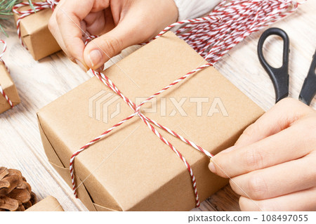 Gift wrapping. Woman packs gifts. wrapping step by step Gift wrapping. Woman packs gifts. wrapping step by step 108497055