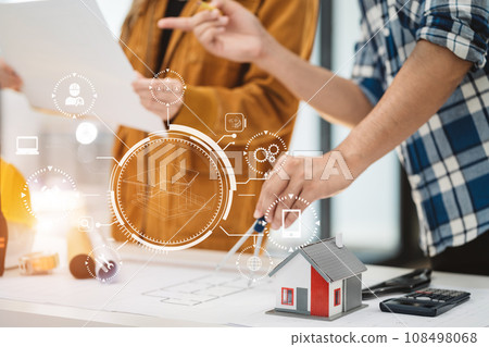 Two colleagues discussing data working and tablet, laptop with on on architectural project at construction site at desk in office. Two colleagues discussing data working and tablet, laptop with on on architectural project at construction site at desk in office. 108498068