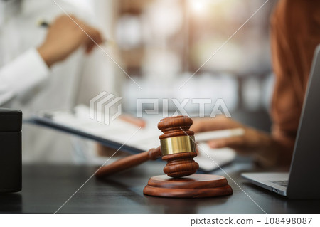 Teamwork of business lawyer meeting working hard about legal legislation in courtroom to help their customer. Teamwork of business lawyer meeting working hard about legal legislation in courtroom to help their customer. 108498087