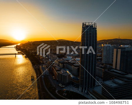 Aerial view of Bratislava city with riverbank of Danube river, during beautiful sunset. 108498751