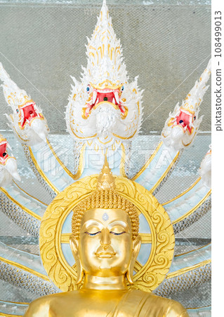 Naga Prok Buddha image sitting cross legs with legs locked together and having a King of Nagas behind it. 108499013