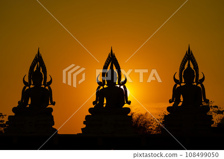 Silhouette Buddha statue between creating and building process, at outdoor field with the sun set and twilight period time., Thailand. 108499050