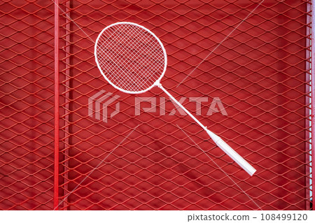one badminton racket is hung on red grill by a cable tie for display in exhibition sports event one badminton racket is hung on red grill by a cable tie for display in exhibition sports event 108499120