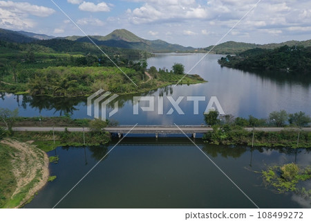 View from the top of a bridge in Thailand, surrounded by a river and various trees. View from the top of a bridge in Thailand, surrounded by a river and various trees. 108499272