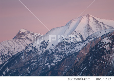 Snow-capped peaks at sunset. 108499576