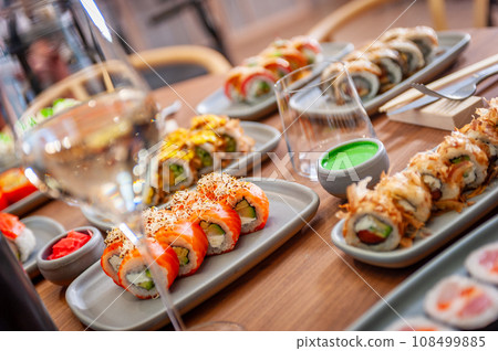 A set of sushi rolls on a table in a restaurant. A set of sushi rolls on a table in a restaurant. 108499885
