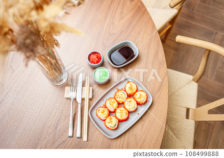 Sushi roll with cream cheese, sesame seeds and green flying fish caviar Sushi roll with cream cheese, sesame seeds and green flying fish caviar 108499888