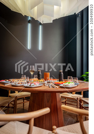 A set of sushi rolls on a table in a restaurant. A set of sushi rolls on a table in a restaurant. 108499910