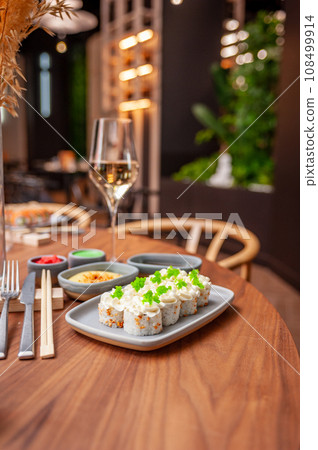 Sushi roll with cream cheese, sesame seeds and green flying fish caviar Sushi roll with cream cheese, sesame seeds and green flying fish caviar 108499914