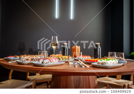 A set of sushi rolls on a table in a restaurant. A set of sushi rolls on a table in a restaurant. 108499929