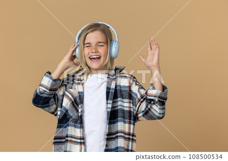 Pretty teen girl in headphones enjoying music 108500534
